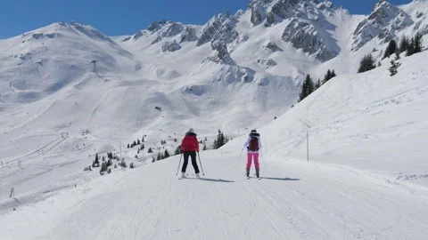 Young skiers developing technique under professional supervision outdoors Stock Footage 322175263