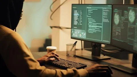 Young skilled thief doing illegal security breach late at night Stock Photos