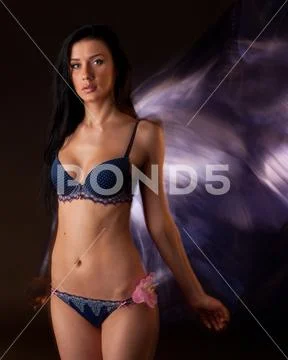 Young slim beautiful brunette woman with long hair in sexy lingerie  standing ~ Hi Res #123011233