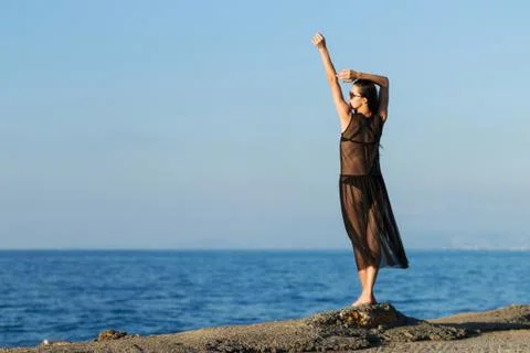 Young slim gitl looking to the ocean Stock Photos