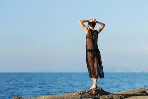 Young slim gitl looking to the ocean Stock Photos
