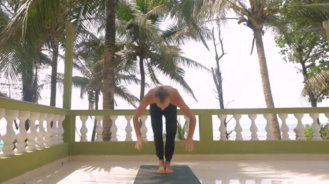 Young slim man doing ashtanga yoga in India Stock Footage 61750362