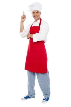 Young smart chef pointing index finger upwards Stock Photos