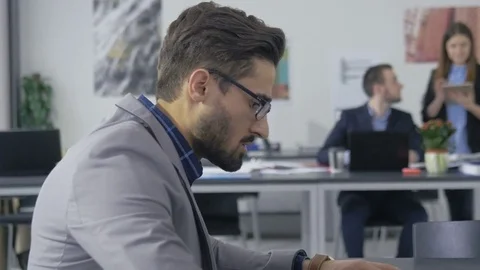 Young smart employee in a jacket working in the office Stock Footage 73992271