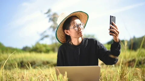 Young smart farmer using computer laptop Stock Footage 97857573