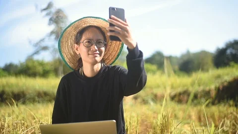 Young smart farmer using smartphone check price Stock Footage 97857501