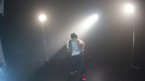 Young smart guy dances like a wide crane down Stock Footage 22824854