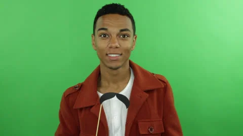 Young smart guy holds a funny Mustache with stick on his hand Stock Footage 22844779