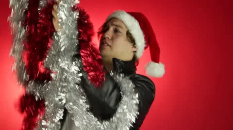 Young smart guy tries to remove the knot in the decorative papers Stock Footage 22555319