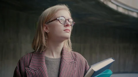 Young smart nerd or geek girl in glasses looking to bright future of science Stock Footage 104672489