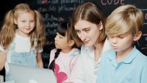 Young smart teacher using laptop to teach student programing system. Erudition. Video stock 282454605