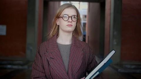 Young smart trendy nerd or geek girl in glasses looking to bright future Stock Footage 104785050