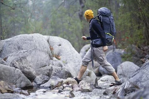 A young smiley man with a backpack Stock Photos