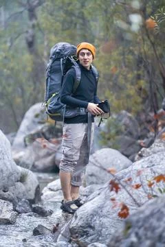 A young smiley man with a backpack Stock Photos