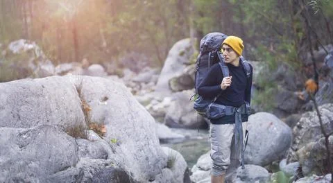 A young smiley man with a backpack . Stock Photos