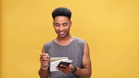 Young smiling african man making notes isolated Stock Footage