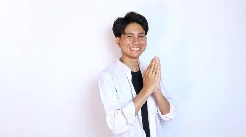 Young smiling Asian man gesturing welcome 写真素材