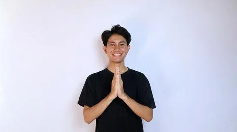 Young smiling Asian man gesturing welcome Stockfoto's