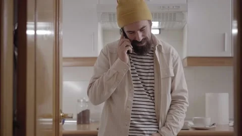 Young smiling Caucasian man using and talking on cell phone. Happy people in the Stock Footage 233438300