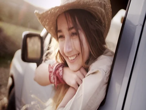Young smiling country girl sitting in a pick-up truck Stock Footage