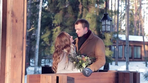 Young smiling couple in the back yard of a house with flowers Stock Footage 72316757