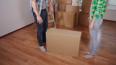 Young smiling couple moving in new home Stock Footage 78658779