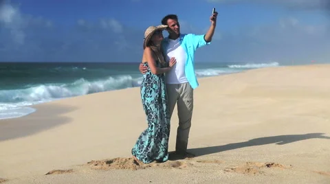 Young Smiling Couple Taking Selfie On Beach Stock Footage 55820758
