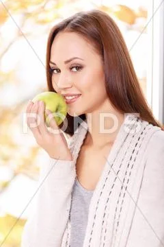 Young smiling girl is about to eat apple Stock Photos