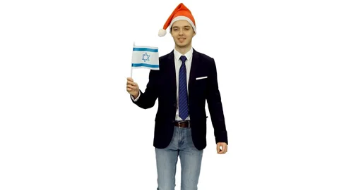 Young smiling guy in santa hat moving forward with flag of Israel, alpha channel Stock Footage 121561442