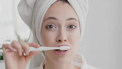 Young smiling happy attractive caucasian woman in towel on head holding Stock Footage 166314088