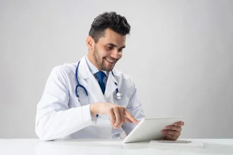 Young smiling internist using tablet computer Stock Photos