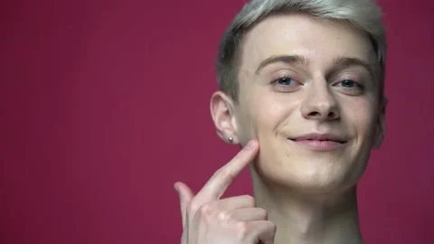Young smiling man applying cream on face in bathroom. Skin care, morning routine Stock-Footage 155462273