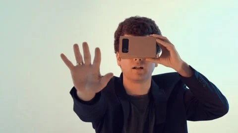 Young smiling man tries a virtual reality headset Stock Footage 63187730