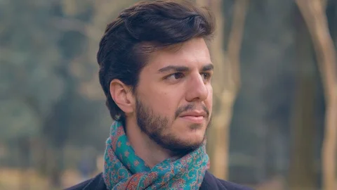 Young smiling man turning head and smiling at camera 스톡 동영상 121360182