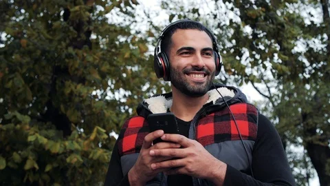 Young Smiling Man Using his Smartphone while Walk on the Street.  Stock Footage 99240355
