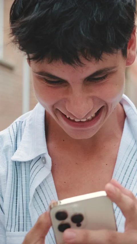 Young smiling man using mobile phone outside Stock Footage 255965629