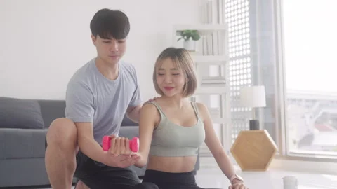 Young smiling multi ethnic couple exercising together at home Stock Footage 248587204