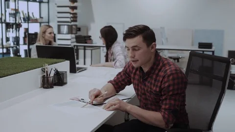 Young smiling office worker in design studio Stock Footage 84726096