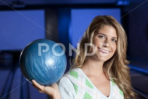 Young smiling woman holding bowling ball Stock Photos