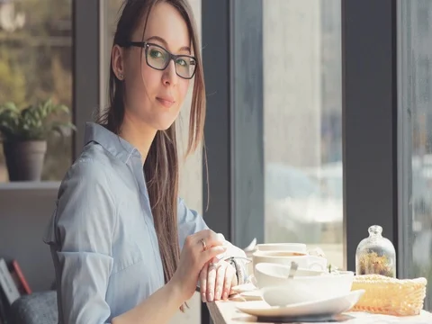 Young Smiling Woman Portrait in a Cafe. 4K SLOW MOTION, DCi. Stock Footage