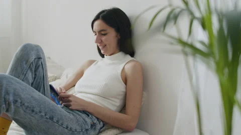 Young Smiling Woman Using Mobile Phone At Home. Stock Footage 220726728