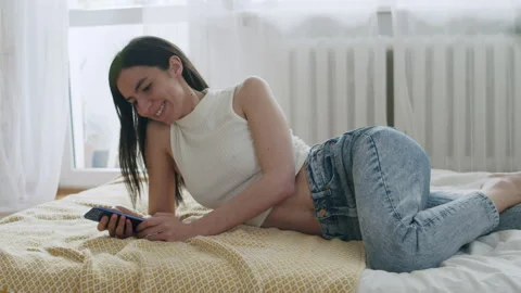 Young Smiling Woman Using Mobile Phone At Home. 스톡 동영상 220727708