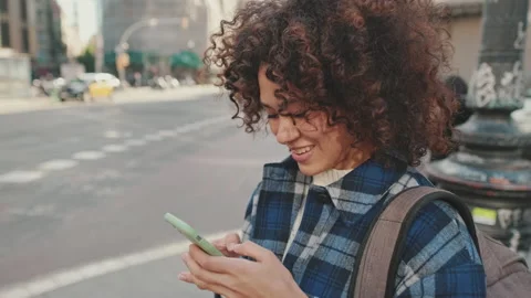 Young smiling woman using mobile phone Stockbeeldmateriaal 237318465
