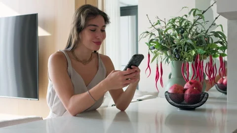 Young smiling woman using smartphone browsing, shopping online Stock Footage 304632186