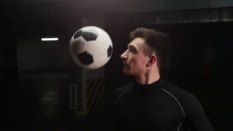 A young soccer man hitting the ball with his shoulder and catch the ball on his Stock Footage 105562071