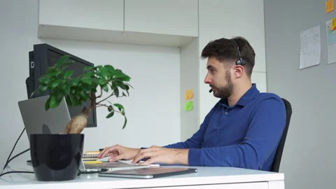 Young software develeoper having call writing computer code Stock Footage 162469299