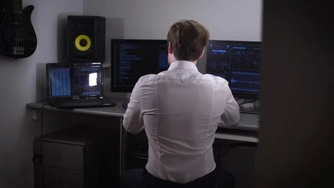 Young software developer analyzes and uses many electronic devices Stock Footage 72446522