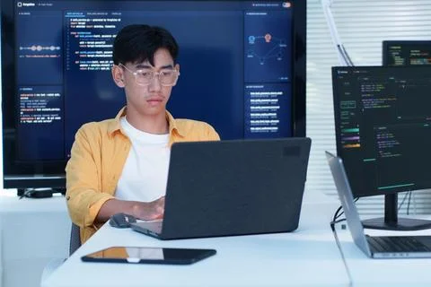 Young Software Developer Coding with Laptop and Artificial Intelligence Fotos Stock