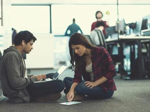 Young software developers couple working on the floor 스톡 사진