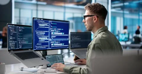 Young Software Engineer Coding On Laptop To Build Secure Business Platform. Stock Photos